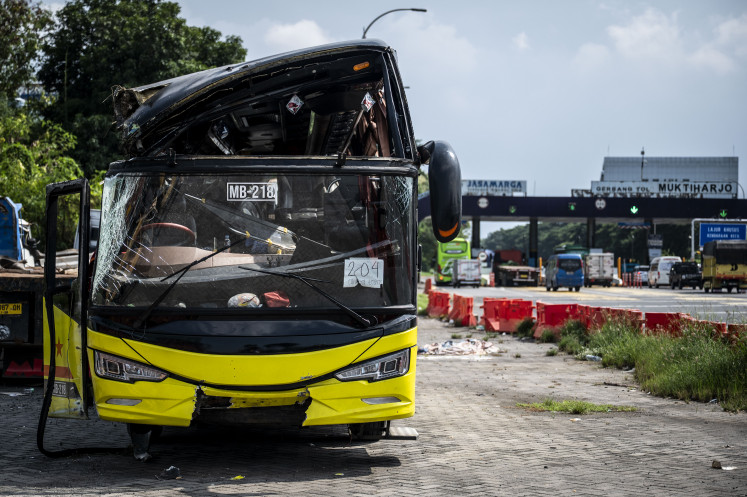 The wreckage of the Cahaya Trans bus is seen on Monday, Dec. 22, 2025, after an accident near the Muktiharjo tollgate in Semarang, Central Java. According to the Joint Emergency Post for Christmas 2025 and New Year 2026, 16 passengers were killed and 18 others were injured in the bus crash on the Jatiasih-Yogyakarta route early on Monday.
