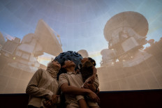 Visitors watch a sky simulation show at the Jakarta Planetarium and Observatory on Dec. 25, 2025. The facility reopens after years of closure for renovations, now featuring upgraded facilities and technology to enhance astronomy education for the public. 