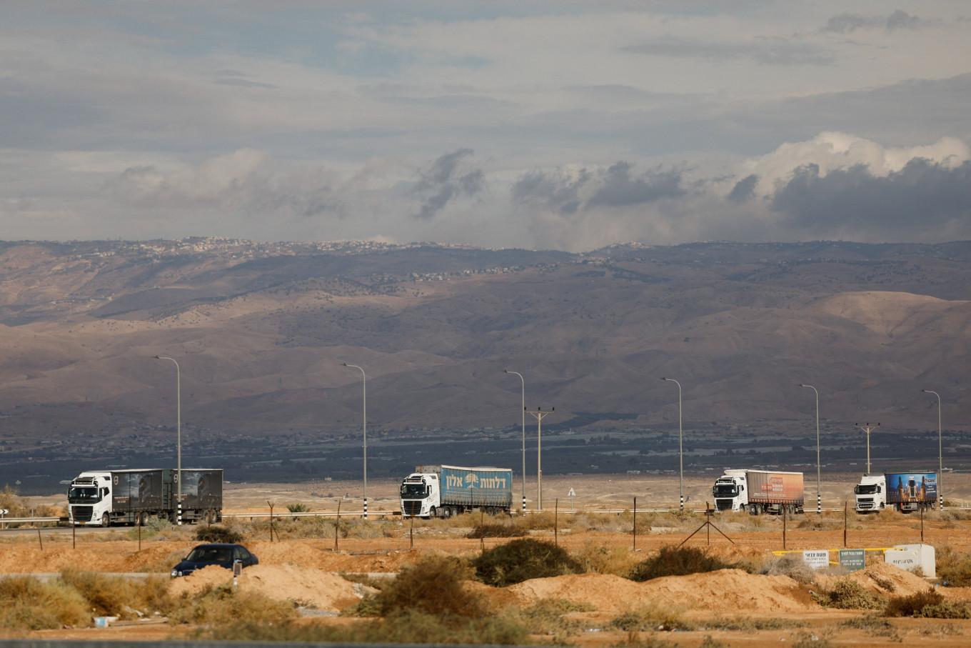 Trucks carrying goods from Jordan move near the Allenby Bridge Crossing between the West Bank and Jordan after it was reopened, in the Israeli-occupied West Bank, on Dec. 10, 2025. The UN says the crossing is a major route for bringing food, tents and other goods into Gaza.