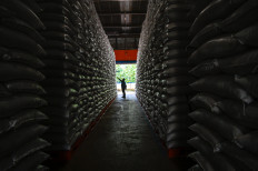 A worker inspects sacks of rice on Dec. 29, 2025, at the State Logistics Agency (Bulog) warehouse in Lambaro, Aceh.