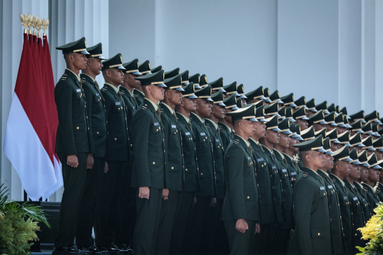 New Indonesian Army officers pose for pictures during a commissioning ceremony for around 2,000 graduates from military and police academies on July 23 at the Presidential Palace in Jakarta.
