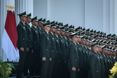 New Indonesian Army officers pose for pictures during a commissioning ceremony for around 2,000 graduates from military and police academies on July 23 at the Presidential Palace in Jakarta.