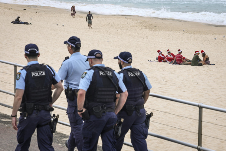 Holiday guard: Police officers patrol on Christmas Day, on Thursday, Dec. 25, 2025, along a promenade at Bondi Beach in Sydney, Australia.