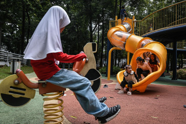 Children play at Puring Park in Jakarta on Dec. 28, 2025. Green open spaces which feature children&rsquo;s playgrounds and fountains offer a free alternative recreational destination for the public. 