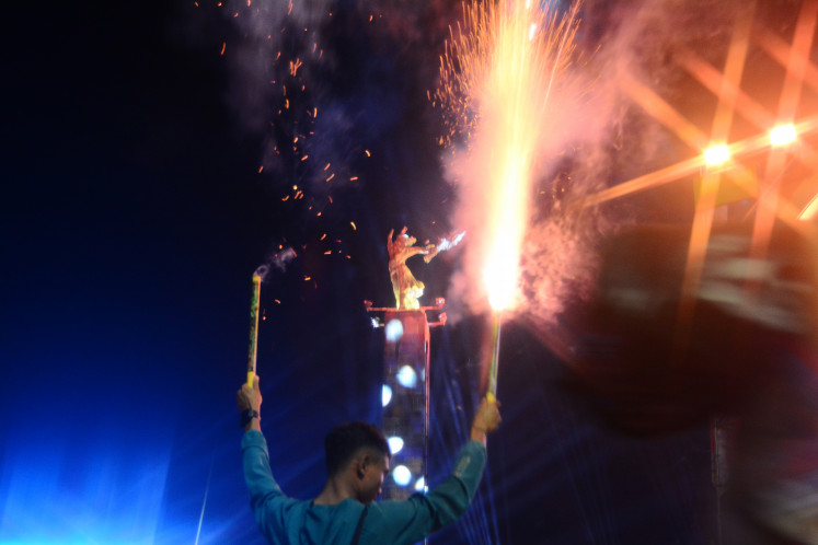 A man sets off fireworks on Jan. 1, 2026, during New Year celebrations at the Hotel Indonesia traffic circle in Central Jakarta, Indonesia. Indonesia limited New Year celebrations and banned official fireworks displays in solidarity with victims of recent catastrophic floods in Sumatra.