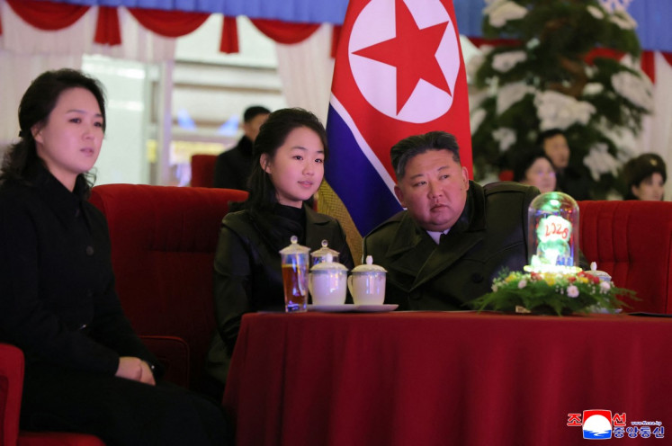 This picture taken on Dec. 31, 2025 and released by North Korea's official Korean Central News Agency (KCNA) via KNS on Jan. 1, 2026 shows North Korean leader Kim Jong Un, his daughter Kim Ju Ae (center) and wife Ri Sol Ju (left) watching a New Year's celebration performance at the May Day Stadium in the capital Pyongyang.