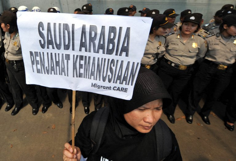 An activist holds a banner reading &ldquo;Saudi Arabia, is a criminal of humanity&ldquo; during a protest against the execution of Indonesian migrant worker Ruyati outside the Saudi Arabian embassy in Jakarta, in this file photo taken on June 21, 2011.