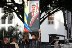 A supporter of Venezuela's President Nicolas Maduro holds up a portrait of him in Catia, Caracas, Venezuela on Jan. 3, 2026. United States President Donald Trump said Saturday that US forces had captured Venezuela's leader Nicolas Maduro after bombing the capital Caracas and other cities in a dramatic climax to a months-long standoff between Trump and his Venezuelan arch-foe.