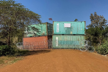 This handout photograph taken and released by Agence Kampuchea Press (AKP) on Jan. 2, 2026 shows Thailand's national flag on containers and barbed wire blocking a street following clashes between Cambodian and Thai soldiers in Chouk Chey village, Banteay Meanchey province, Cambodia. Cambodia said on Jan. 2 that Thai forces had taken control of a disputed border village, accusing Thailand of &ldquo;annexing&ldquo; the area after a truce on Dec. 27 halted deadly fighting along their contested frontier.