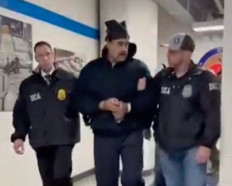 This screengrab taken from the X account of Rapid Response 47, the official White House rapid response account, shows Venezuelan President Nicolas Maduro (center) escorted by DEA agents inside the headquarters of the US Drug Enforcement Administration (DEA) in lower Manhattan, New York, on January 3, 2026. 