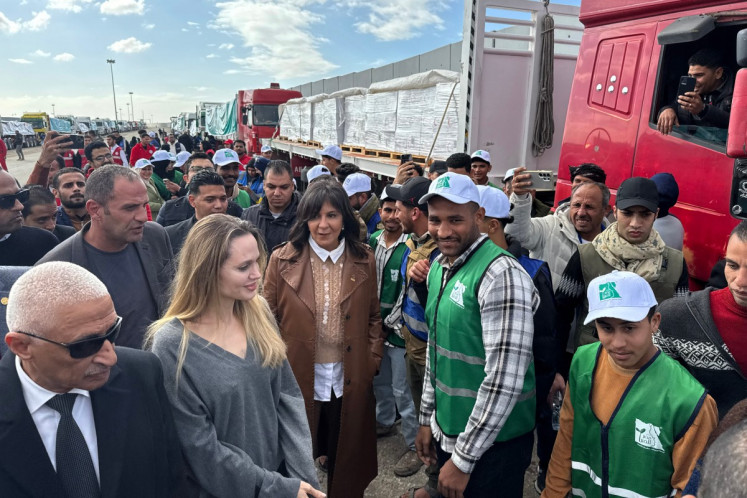 US actress Angelina Jolie speaks to employees of aid agencies at the Egyptian Rafah border crossing, part of her visit to the North Sinai Governorate to inspect aid entering the Palestinian Gaza Strip, on January 2, 2026.