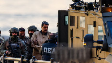 Personnel from the United States Drug Enforcement Administration (DEA) escort Venezuelan President Nicolas Maduro to an armored van at the Downtown Manhattan Heliport in New York City on Jan. 5, 2026, for transporting to the Daniel Patrick Moynihan US Courthouse to face federal charges including narco-terrorism and money laundering.