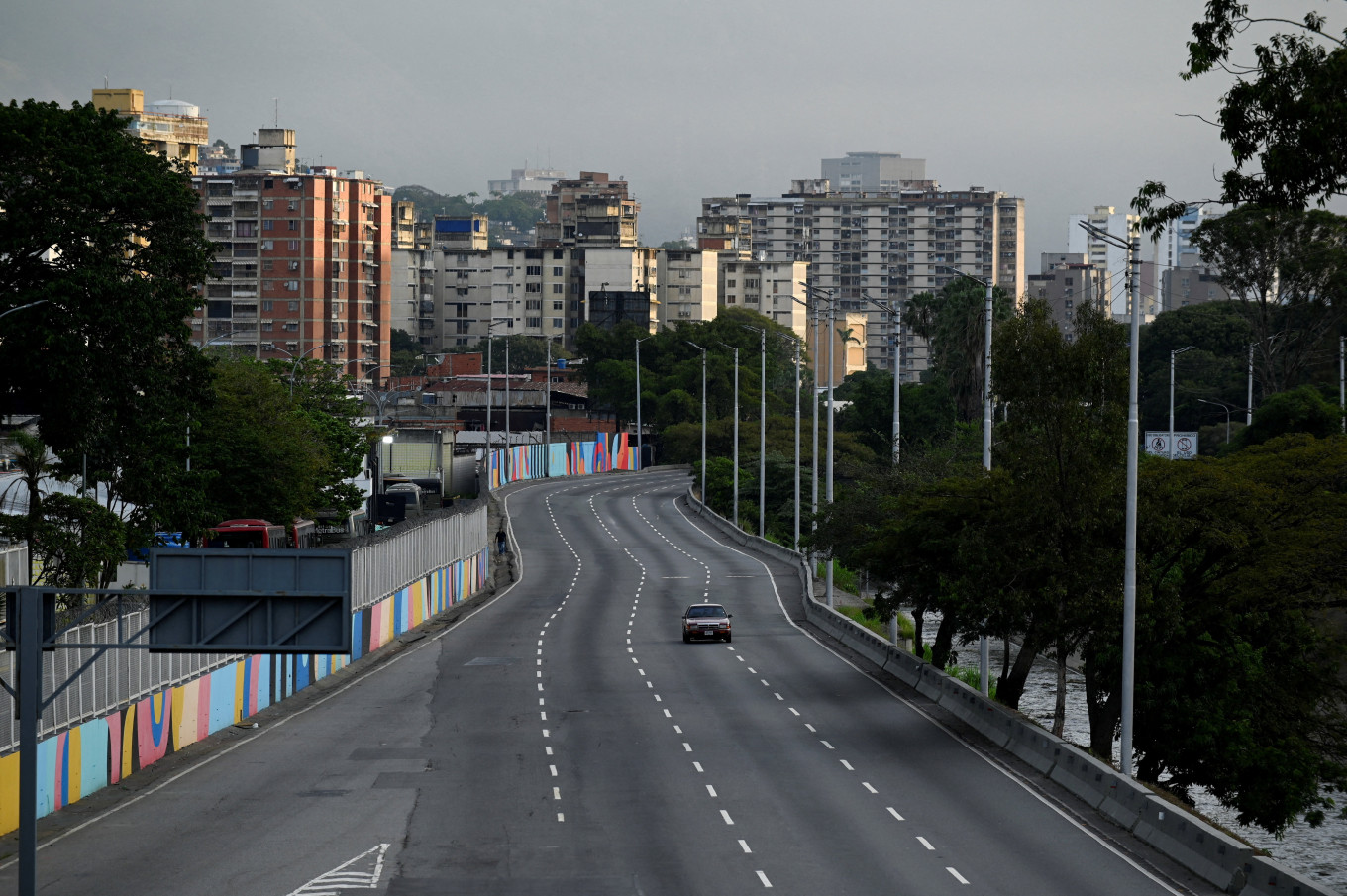 Caracas limbo: A car drives on an empty street on Jan. 3, 2026 after United States President Donald Trump said the US has struck Venezuela and captured its president, Nicolas Maduro, in Caracas.