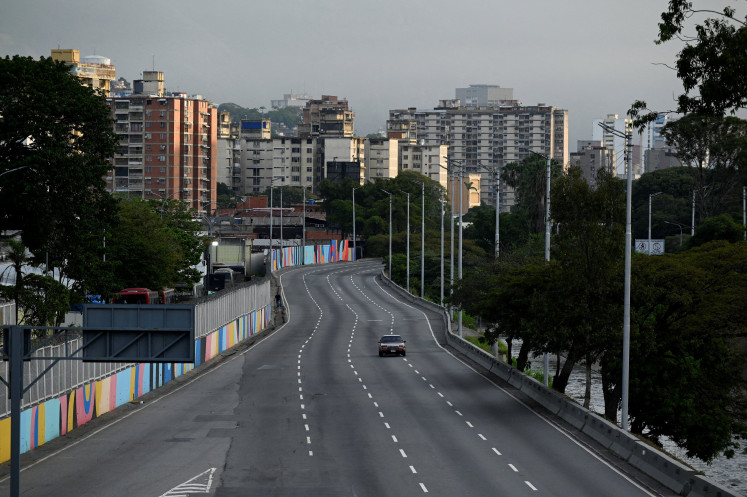 Caracas in limbo: A car drives on an empty street on Saturday, Jan. 03, 2026 after United States President Donald Trump said the US has struck Venezuela and captured its president, Nicolas Maduro, in Caracas.