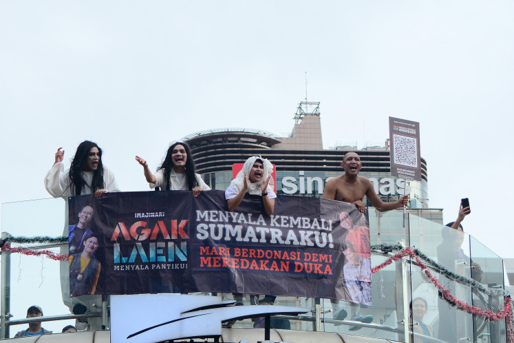 Actors from the Agak Laen movie franchise, (from left) Boris Bokir, Bene Dion, Indra Jegel and Oki Rengga, take part in a charity drive on Dec. 14, 2025, in support of flood victims from northern Sumatra, near the Hotel Indonesia in Central Jakarta.