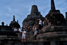 Reach the heights: Tourists capture the moment of the first sunrise of the year on Jan. 1, 2026 at the top of Borobudur Temple in Magelang, Central Java. 

