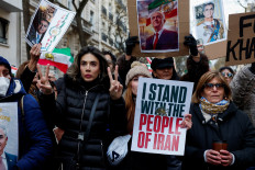 A person holds a picture of Reza Pahlavi, the exiled son of the last Shah of Iran as demonstrators and activists rally in support of nationwide protests in Iran, in Paris, France, January 11, 2026.