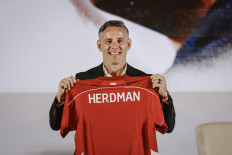 New coach, new hope: New Indonesia national team coach John Herdman displays a team jersey on Tuesday, Jan. 13, 2026, during his introduction event in Jakarta. The Soccer Association of Indonesia (PSSI) officially appointed Herdman as the national team coach, citing his international coaching experience and track record in building national and club teams as part of efforts to boost the competitiveness of Indonesian soccer.