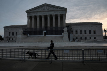 A US Supreme Court Police canine unit patrols in front of the court building at the start of the day in Washington, DC, on Jan. 9, 2026.