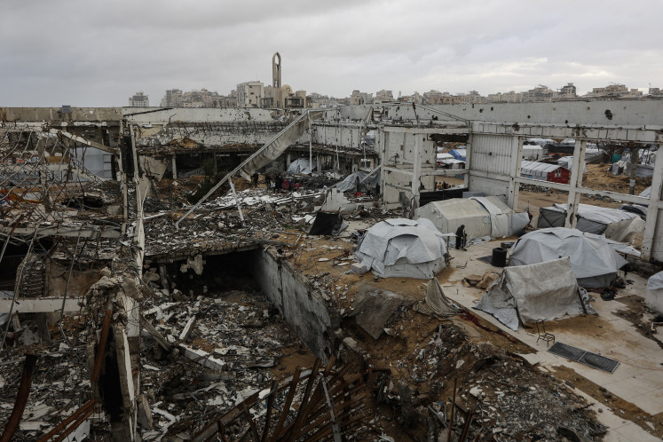 Open wound: Several tents stand on Tuesday, Jan. 13, 2026, at a makeshift shelter within the frame of a destroyed building in Gaza City, parts of which collapsed in strong winds.
