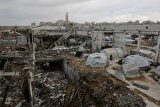 Open wound: Several tents stand on Tuesday, Jan. 13, 2026, at a makeshift shelter within the frame of a destroyed building in Gaza City, parts of which collapsed in strong winds.