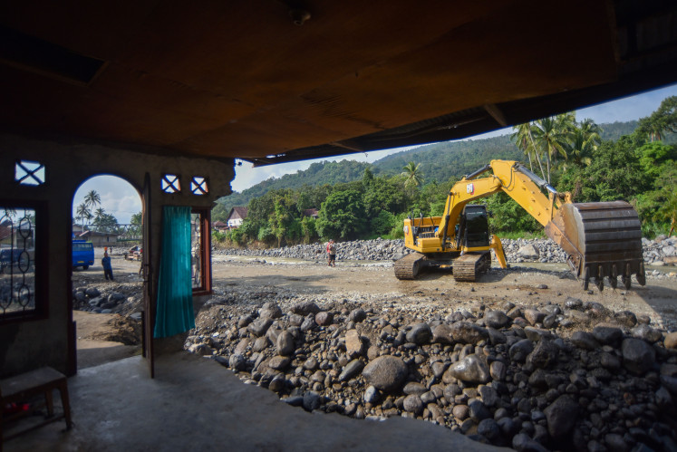 An operator runs heavy equipment on Saturday, Jan. 10, 2026, to normalize a river in Nagari Sumpu, Tanah Datar, West Sumatra. The Tanah Datar administration has proposed about Rp 1.4 trillion (US$82.79 billion) in post-disaster recovery funding to the central government, including more than Rp 1.3 trillion for infrastructure, around Rp 92.9 billion for housing, Rp 49 billion for the economy, over Rp 6.7 billion for social programs and more than Rp 10 billion for cross-sector needs.