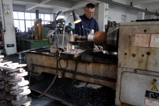 An employee works on the production line manufacturing pipe-fitting valves at a factory in Wenzhou, Zhejiang province, China, on Jan. 14, 2026.