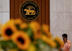 A man speaks on his phone as he walks past the Reserve Bank of India (RBI) logo inside its headquarters in Mumbai, India, on Feb. 7, 2025.