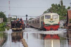 A train passes through floodwaters in Tirto, Pekalongan city, Central Java, on Jan. 18, 2026. The Pekalongan city administration has declared a 14-day emergency response period from Jan. 17 to 31, 2026, following flooding that affected 8,692 households and displaced 1,472 residents. 