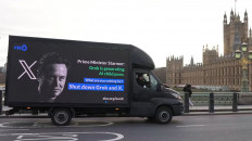 A billboard passes through Westminster on Jan. 14 urging United Kingdom Prime Minister Keir Starmer to stand up to Elon Musk and ban X and Grok.