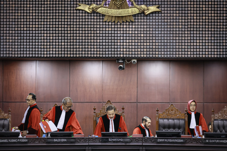 Constitutional Court Chief Justice Suhartoyo (center), together with his deputy Saldi Isra (second left) and three other Constitutional Court justices, Ridwan Mansyur (left), Anwar Usman (second right) and Enny Nurbaningsih, prepare to preside over a ruling hearing at the Constitutional Court building in Jakarta on Jan. 19, 2026.