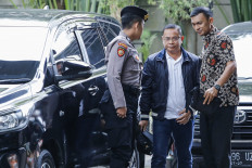 Pati Regent Sudewo (center) is escorted by security officers upon arriving at the Corruption Eradication Commission (KPK) headquarters in Jakarta on Jan. 20, 2026. Sudewo is among several people arrested by KPK investigators in a raid in Pati, Central Java, in a corruption case pertaining to the appointment of village officials in the regency.