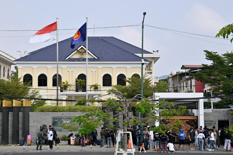 People gather in front of the Indonesian Embassy in Phnom Penh on Monday, Jan. 19, 2026. More than 400 Indonesians were freed by cyber scam networks in Cambodia this month, Jakarta said on the same day.