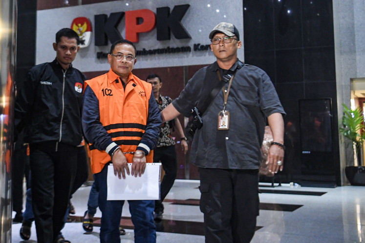 Pati Regent Sudewo (second left) walks by after an examination on Jan. 20, 2026 at the Corruption Eradication Commission (KPK) headquarters in South Jakarta. The KPK named Sudewo a suspect in an alleged corruption case involving extortion in the appointment of village officials, seizing evidence worth 2.6 billion rupiah (US$168,000).