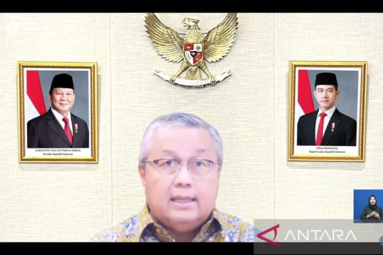 A screenshot shows Bank Indonesia (BI) Governor Perry Warjiyo presenting on Jan. 21, 2026, the results of BI's latest Board of Governors Meeting in an online press conference in Jakarta