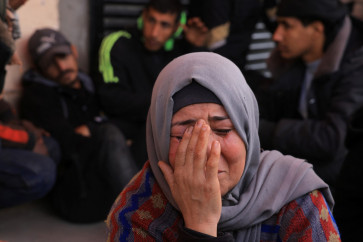 A Palestinian woman mourns after three members of the Al-Rjodi family were killed in an Israeli strike in Deir al-Balah in the central Gaza Strip on Jan. 21, 2026. A US-backed plan to end the war in Gaza has entered its second phase despite unresolved disputes between Israel and Hamas and amid plans to convene a coalition of countries under a Board of Peace.