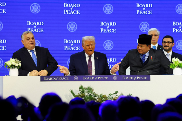  United States President Donald Trump (center) gestures toward President Prabowo Subianto (right) and Hungary's Prime Minister Viktor Orban, as they take part in a charter announcement for his Board of Peace initiative aimed at resolving global conflicts, alongside the 56th annual World Economic Forum (WEF), in Davos, Switzerland, Jan. 22, 2026.