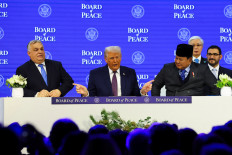 United States President Donald Trump (center) gestures toward President Prabowo Subianto (right) and Hungary's Prime Minister Viktor Orban, as they take part in a charter announcement for his Board of Peace initiative aimed at resolving global conflicts, alongside the 56th annual World Economic Forum (WEF), in Davos, Switzerland, Jan. 22, 2026.