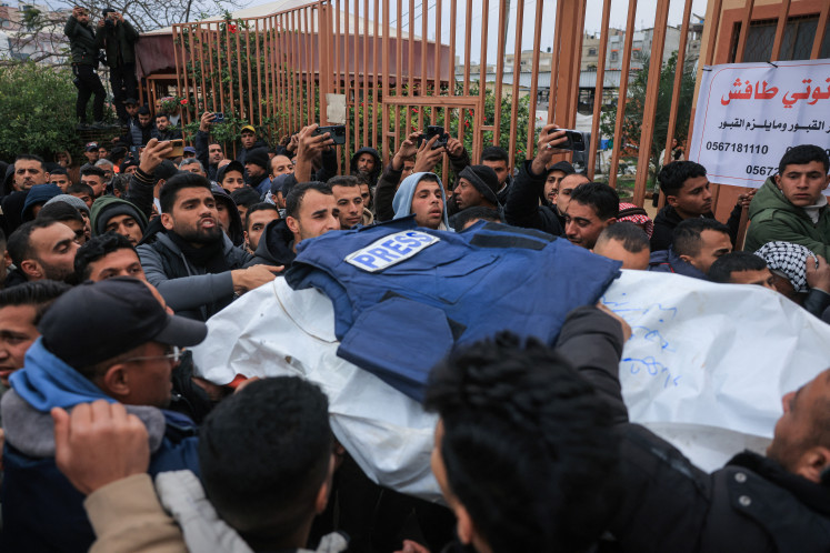 Family members and colleagues carry the bodies of Palestinian journalists killed in an Israeli strike, as they leave the Nasser Hospital for burial on Jan. 21, 2026, in Khan Yunis in the southern Gaza Strip.