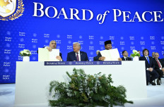 President Prabowo Subianto (right) and Hungary's Prime Minister Viktor Orban (left) hold a signed founding charter next to United States President Donald Trump (center) at the &ldquo;Board of Peace&ldquo; meeting during the World Economic Forum (WEF) annual meeting in Davos on Jan. 22, 2026. Originally meant to oversee the rebuilding of Gaza after the war between Hamas and Israel, the board's charter does not limit its role to the Strip, and has sparked concerns that Trump wants it to rival the United Nations. 