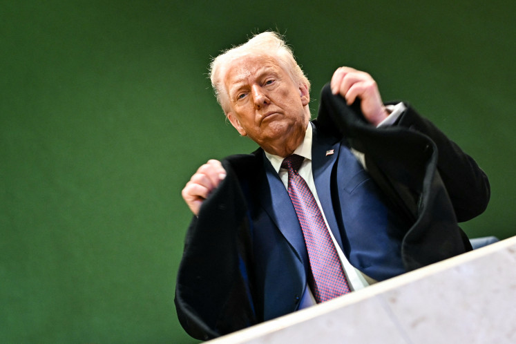 US President Donald Trump adjusts his jacket as he leaves the Congress Centre during the World Economic Forum (WEF) annual meeting in Davos, Switzerland, on Jan. 22, 2026.