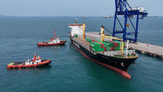 Two tug boats pull a cargo ship carrying four containers holding hazardous e-waste to the United States at Batu Ampar Port in Batam, Riau Islands, on Jan. 20, 2026. 