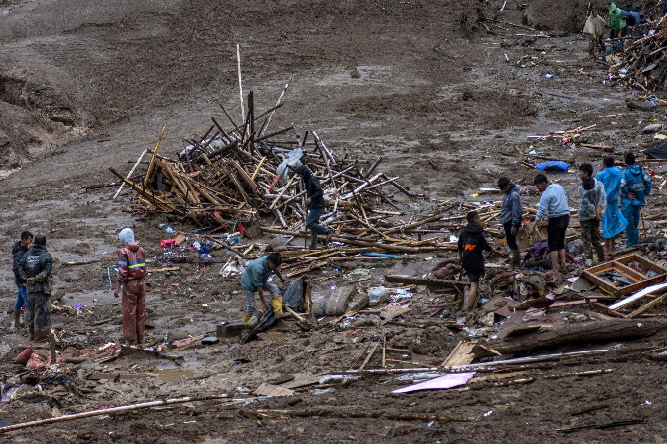 Residents clear debris while searching for landslide victims on Jan. 24, 2026, in Pasirlangu village, Cisarua, West Bandung regency, West Java. An assessment by a joint search and rescue team and local authorities as of 12:30 p.m. showed that 34 families, or 113 people, were affected by the landslide, with 23 survivors, eight people found dead and 82 others still missing. 