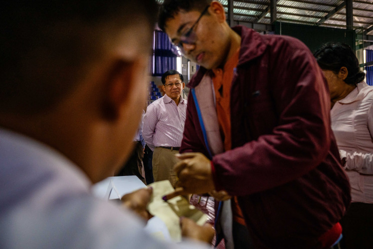 Election gamble: Military chief Min Aung Hlaing (back center) watches a voter ink their finger as he visits a polling station on Sunday, Jan. 25, 2026, during the third and final phase of Myanmar&rsquo;s general election in Mandalay, Myanmar.