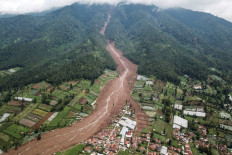 An aerial picture shows a landslide at Pasirlangu village, West Bandung, West Java on January 25, 2026, after the disaster killed 16 people and left around 80 missing.
