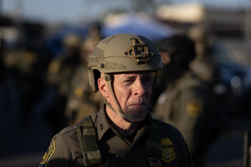 US Border Patrol Chief Greg Bovino leads his troop as they confront demonstrators outside of an immigrant processing center on September 27, 2025 in Broadview, Illinois. 
