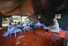 Students of SD 14 Labuah state elementary school in Sungai Batang village, Tanjung Raya, Agam regency, West Sumatra, attend a class under a tent Jan. 27, 2026. 