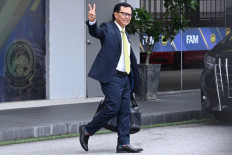 A member of the Football Association of Malaysia's (FAM) executive committee, Kamarudin Hassan, gestures as he leaves after resigning at the FAM's headquarters in Kuala Lumpur on January 28, 2026. The Malaysian soccer association's entire executive committee resigned on January 28, due to an ongoing eligibility scandal linked to forged documents used in Asian Cup qualifying games. 