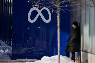 A woman stands near a Meta logo during the 56th annual World Economic Forum (WEF) in Davos, Switzerland, on Jan. 20, 2026. 