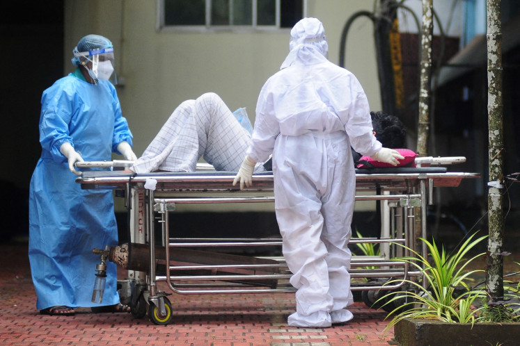 Health workers wearing protective gears shift a man with symptoms of Nipah virus to an isolation ward at a government hospital in Kozhikode in south Indian state of Kerala on September 16, 2023. 